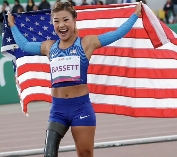 American para-athlete with a running blade holding the stars and stripes