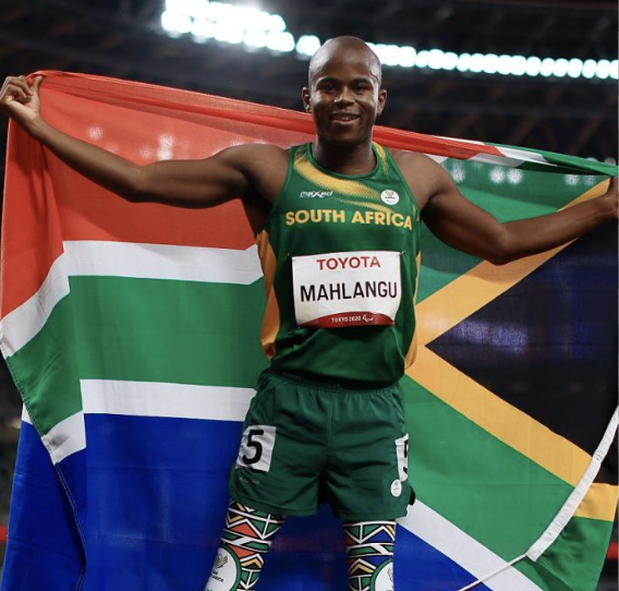 South African para-sprinter celebrating with the national flag
